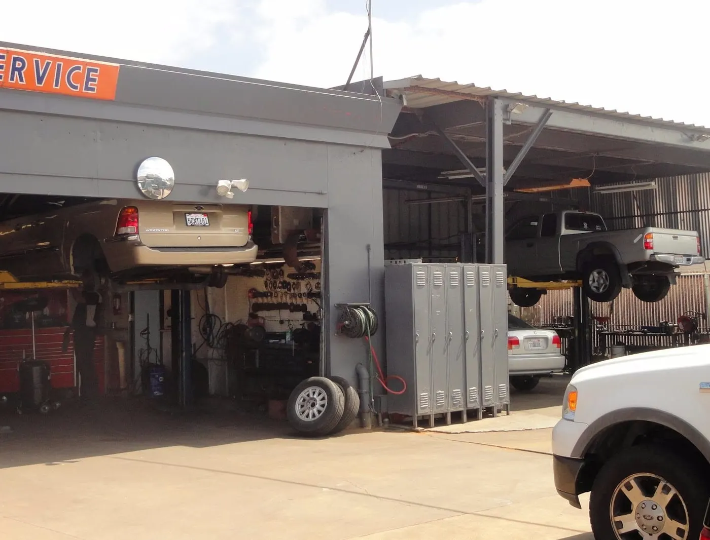 Open shop bay with vehicles on lifts